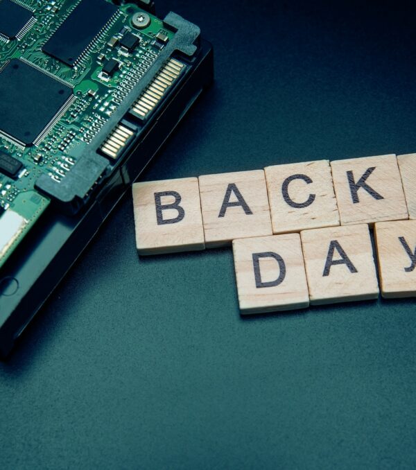 Words in English Backup day. Copy space for text. HDD hard drive. hard disk on black dark background