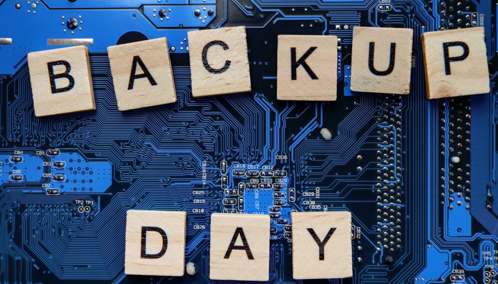 Words in English Backup day. Copy space for text. HDD hard drive. hard disk on black dark background