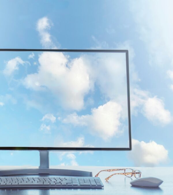 Office in the sky, cloud computing concept. Desktop with keyboard, mouse and coffee.